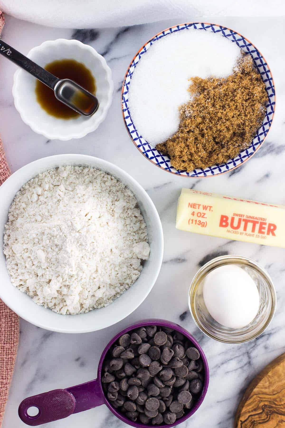 The recipe ingredients in separate bowls and cups on a marble board.