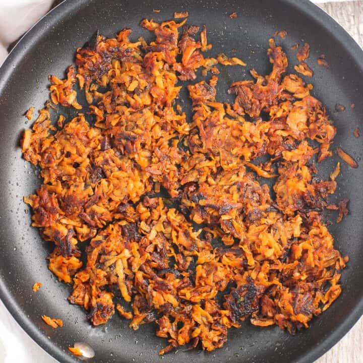 Shredded sweet potato hash browns cooked in a skillet.