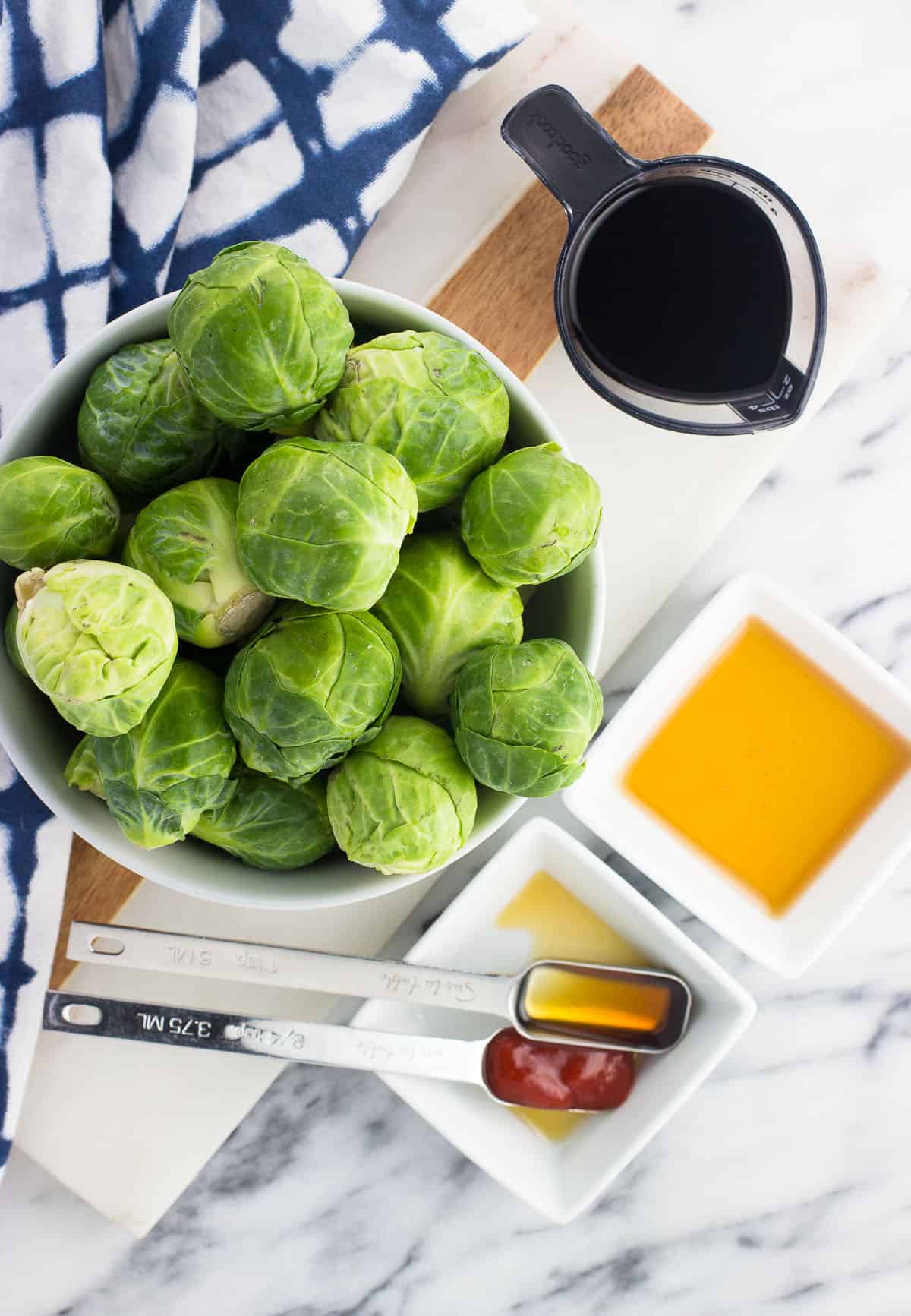 An overhead shot of the recipe ingredients in separate bowls on a marble board