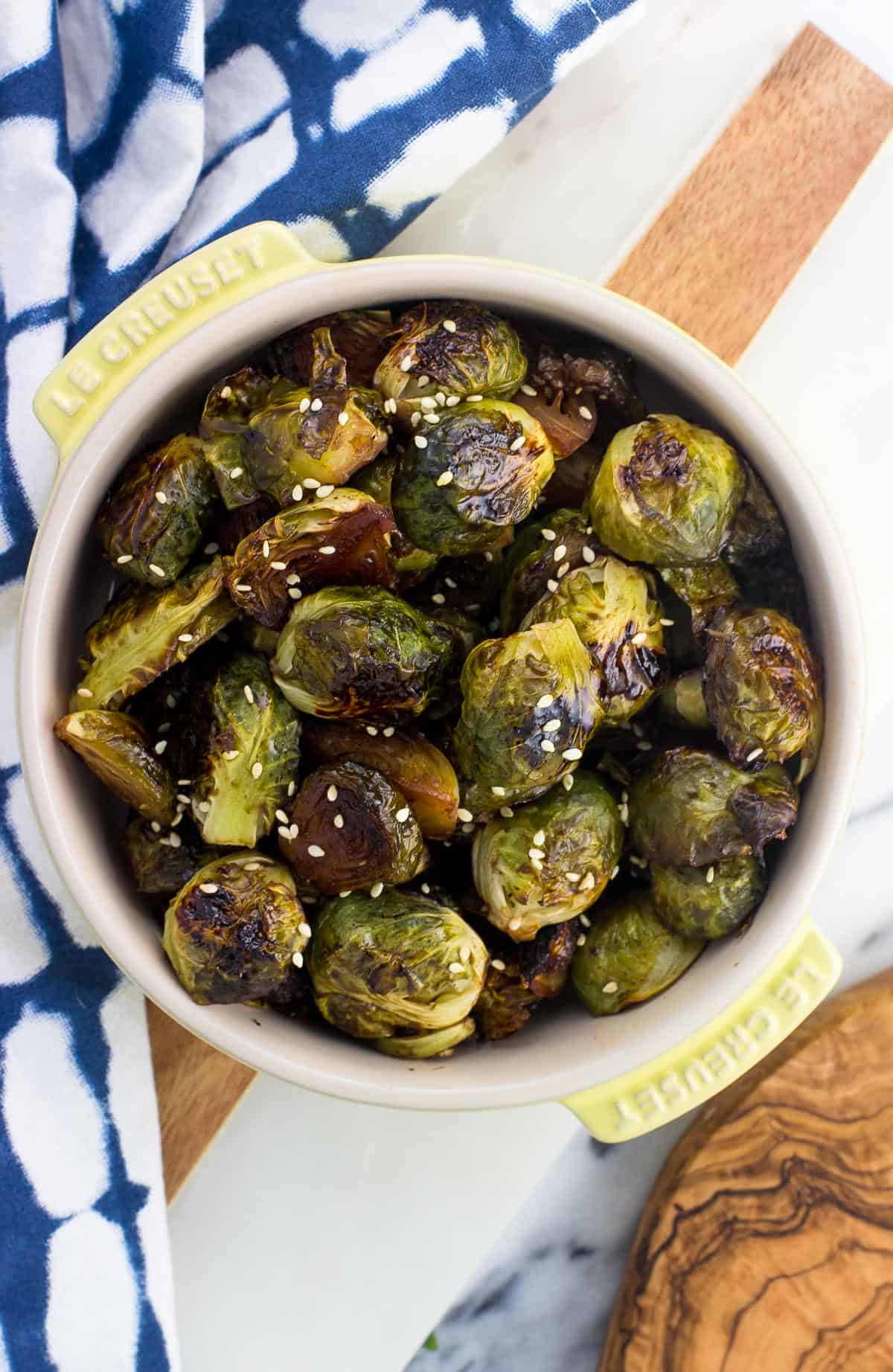 An overhead picture of the roasted and glazed brussels sprouts in a small round ceramic bowl