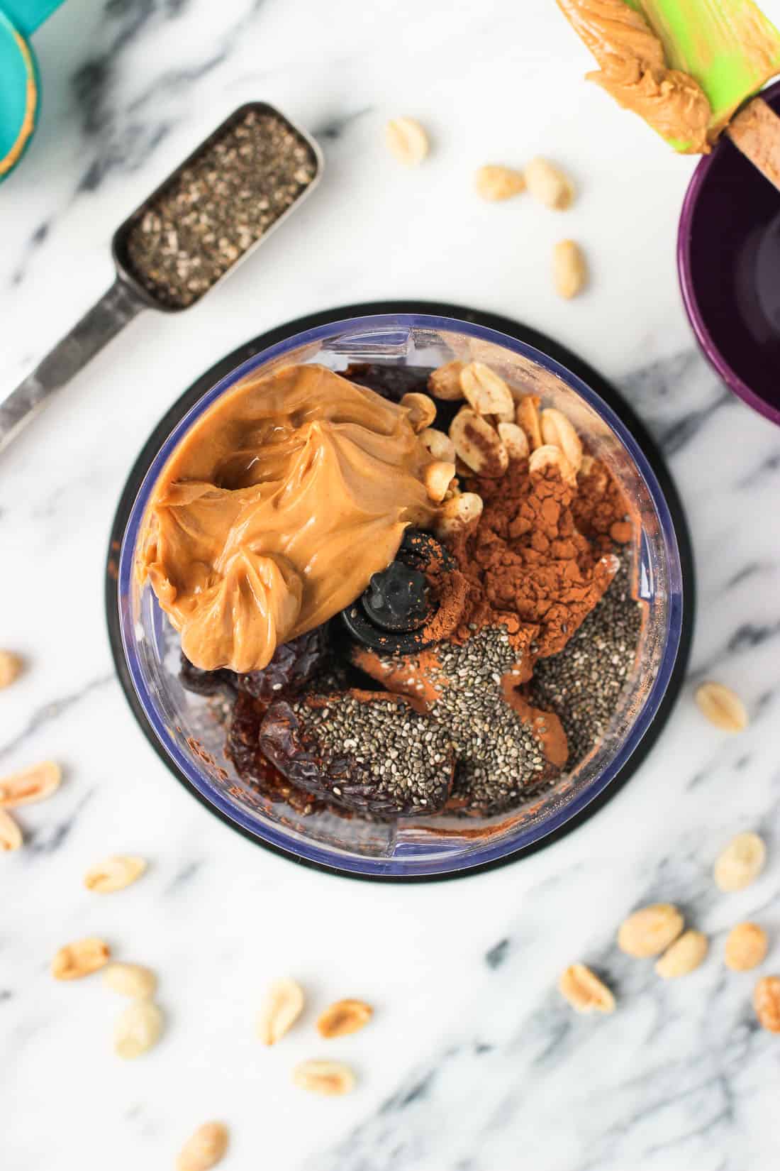 The recipe ingredients in the bowl of a food processor before blending.