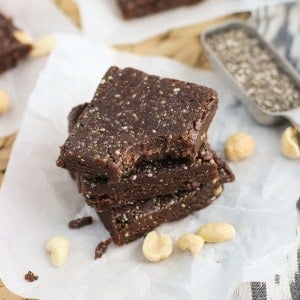 A stack of three chia bars with a bite taken out of the top one.