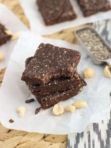 A stack of three chia bars with a bite taken out of the top one.