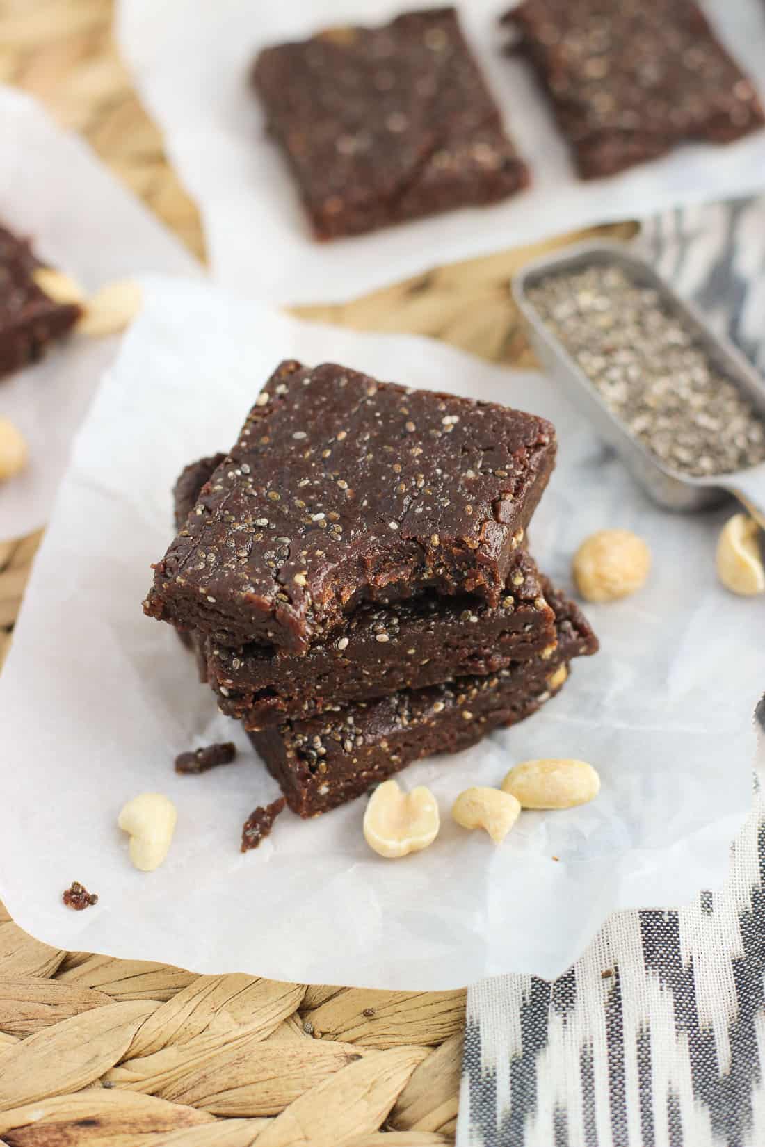 A stack of three chia bars with a bite taken out of the top one.