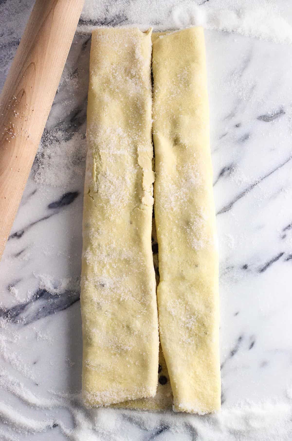 A sheet of puff pastry rolled from both sides to meet in the middle