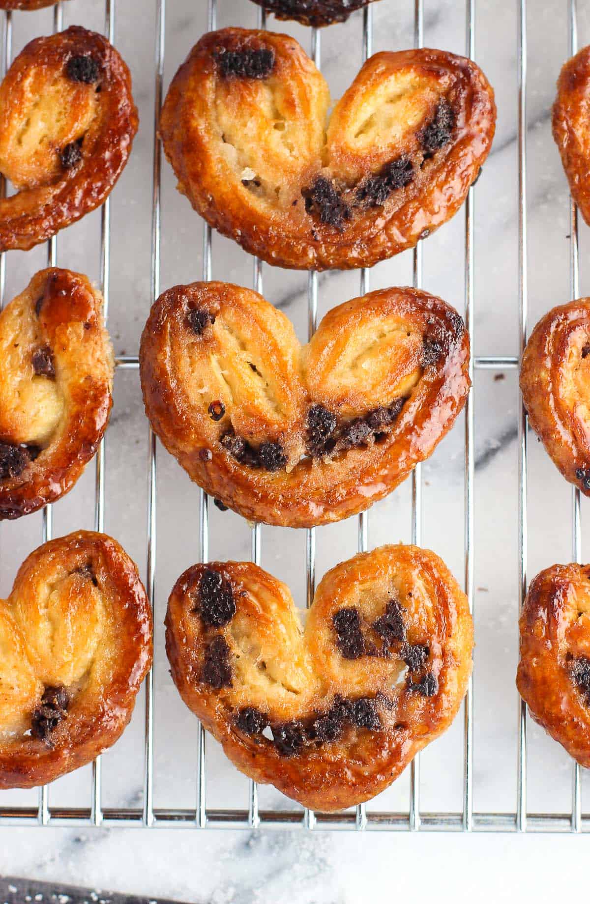 An overhead shot of chocolate chip palmiers on a wire rack