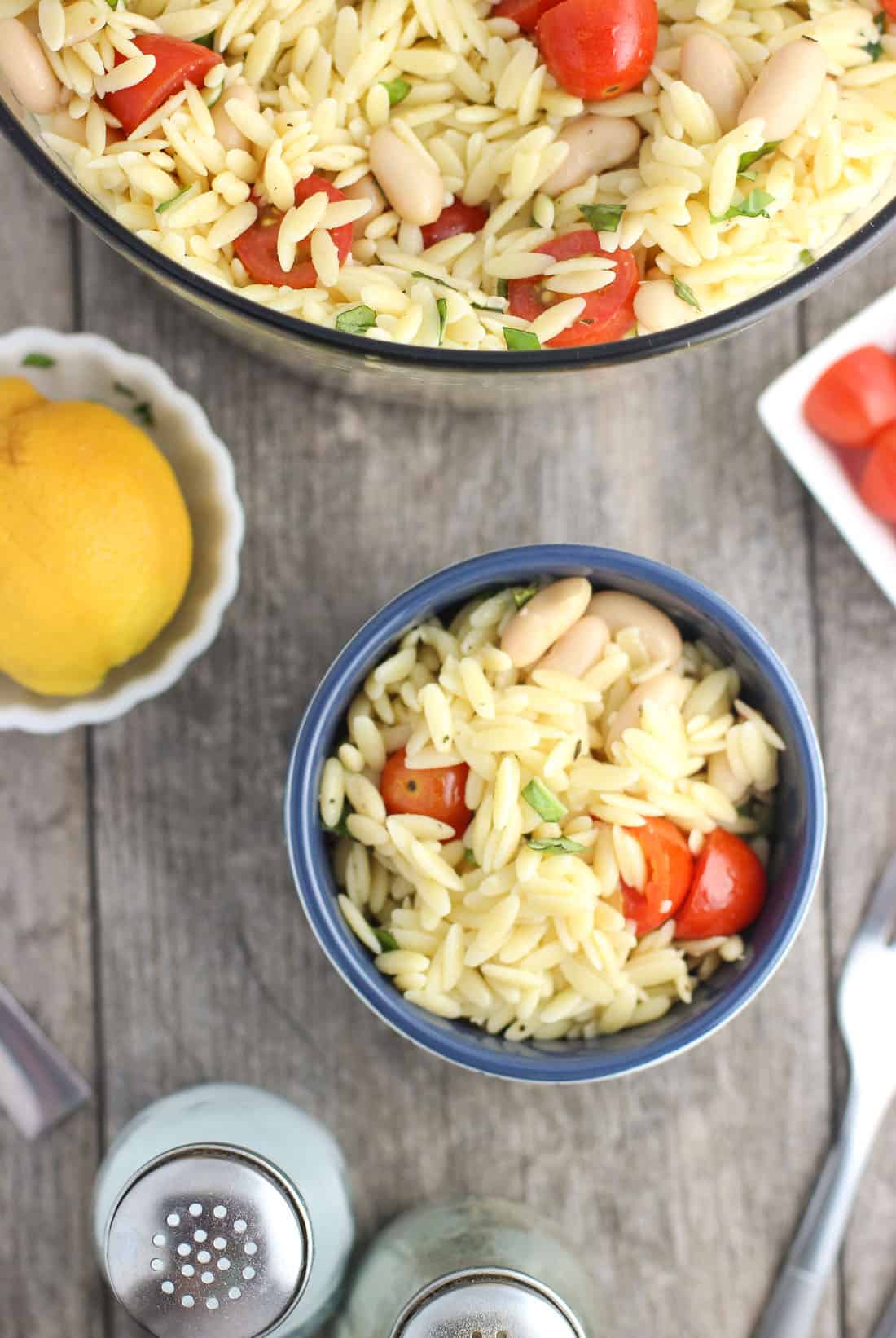 A serving of pasta salad in a small bowl on a table.