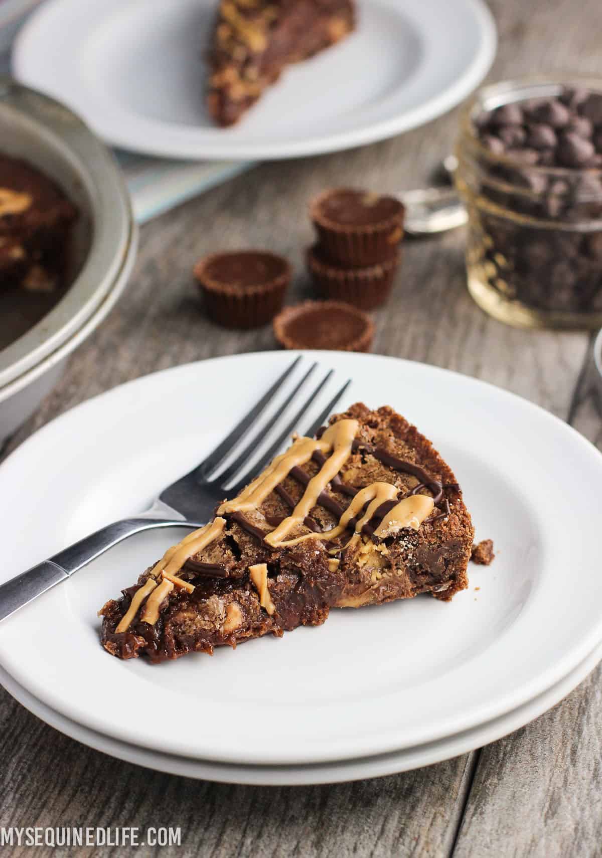 A slice of brownie pie on a plate with a fork.