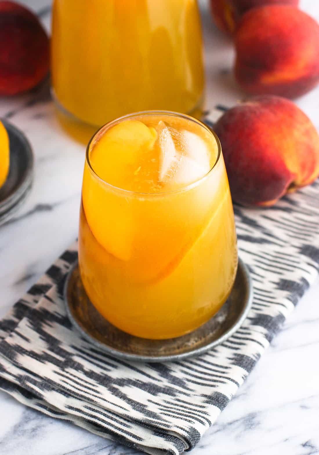 A close-up of a glass of sangria on a metal coaster