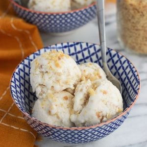 A bowl with several small scoops of ice cream with a spoon.