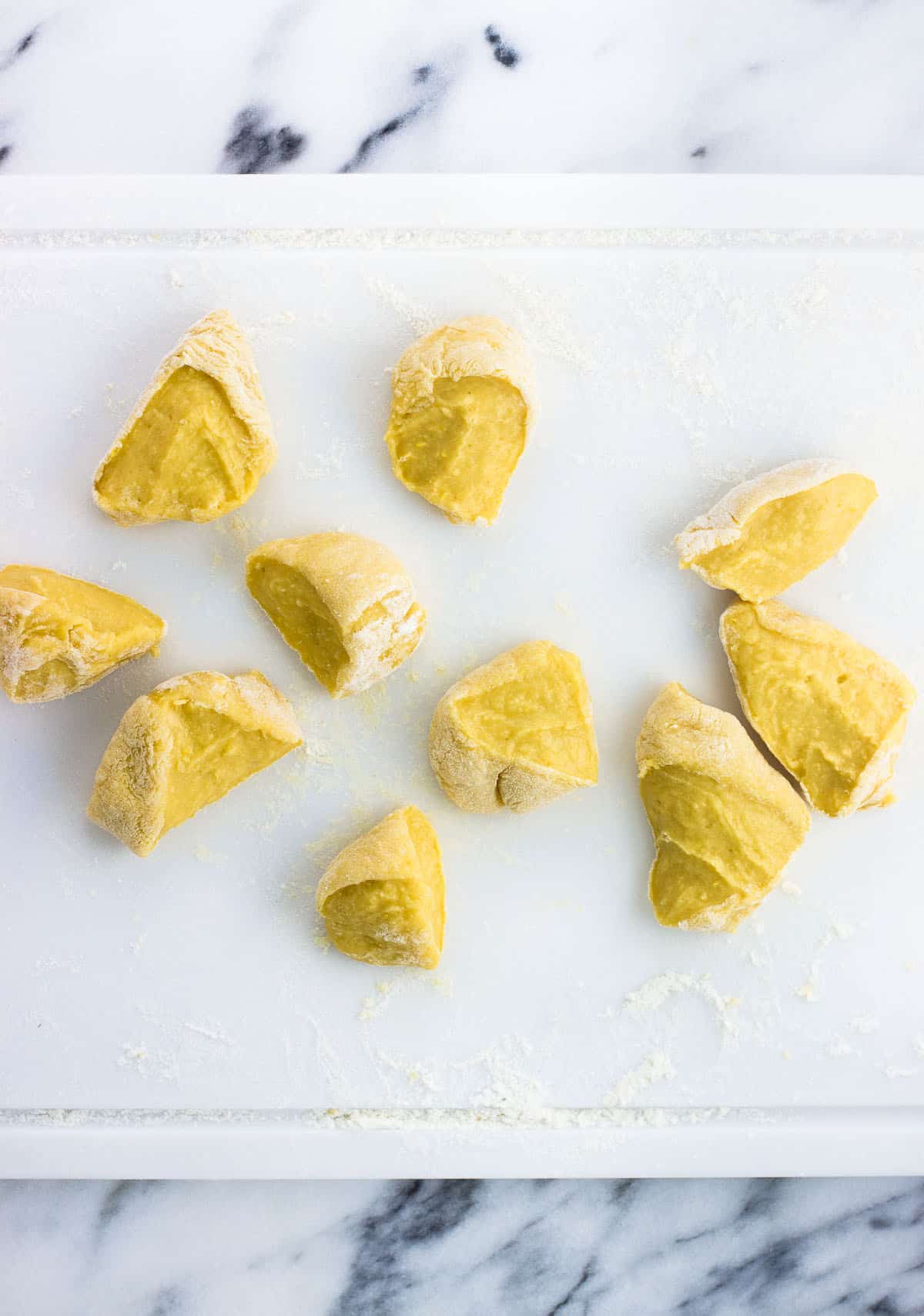 The dough rolled out on a floured cutting board and cut into ten equal sections