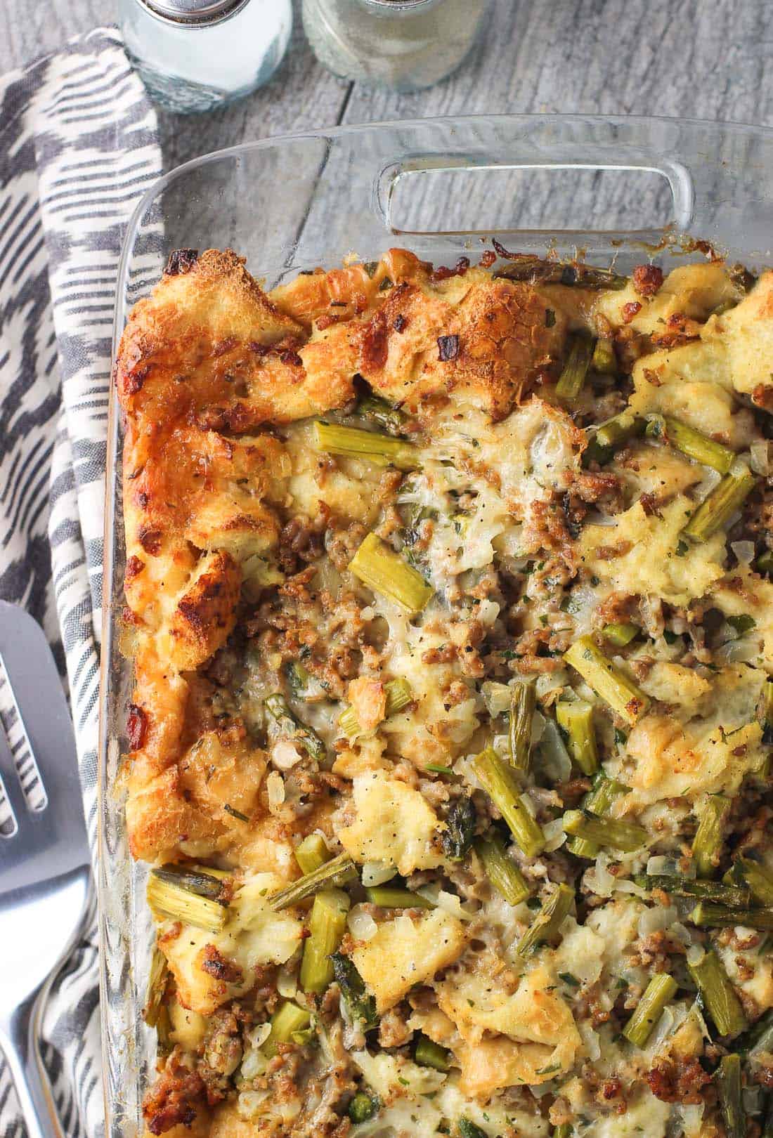Sausage breakfast strata in a large glass rectangular baking dish after being baked and before being sliced