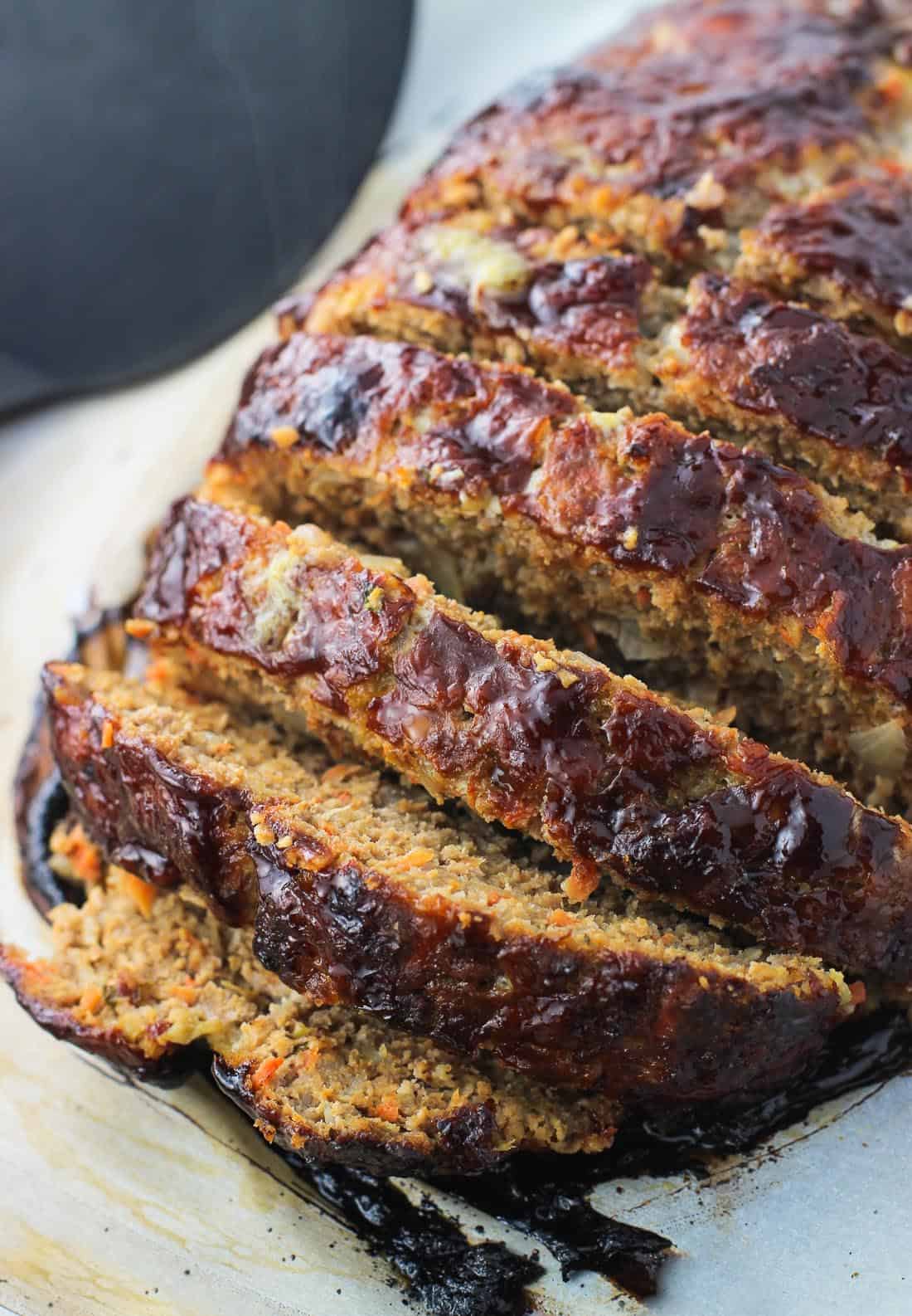 Sliced meatloaf on a baking sheet.