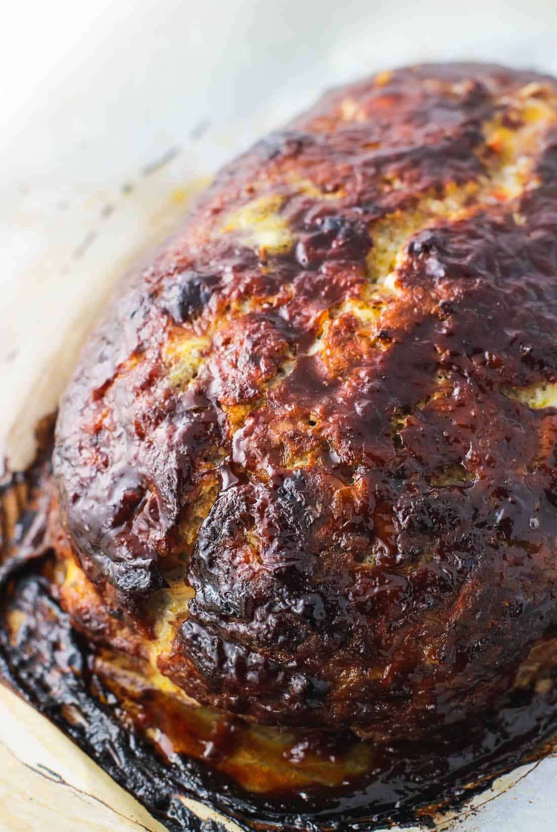 Cooked meatloaf on a baking sheet before slicing.