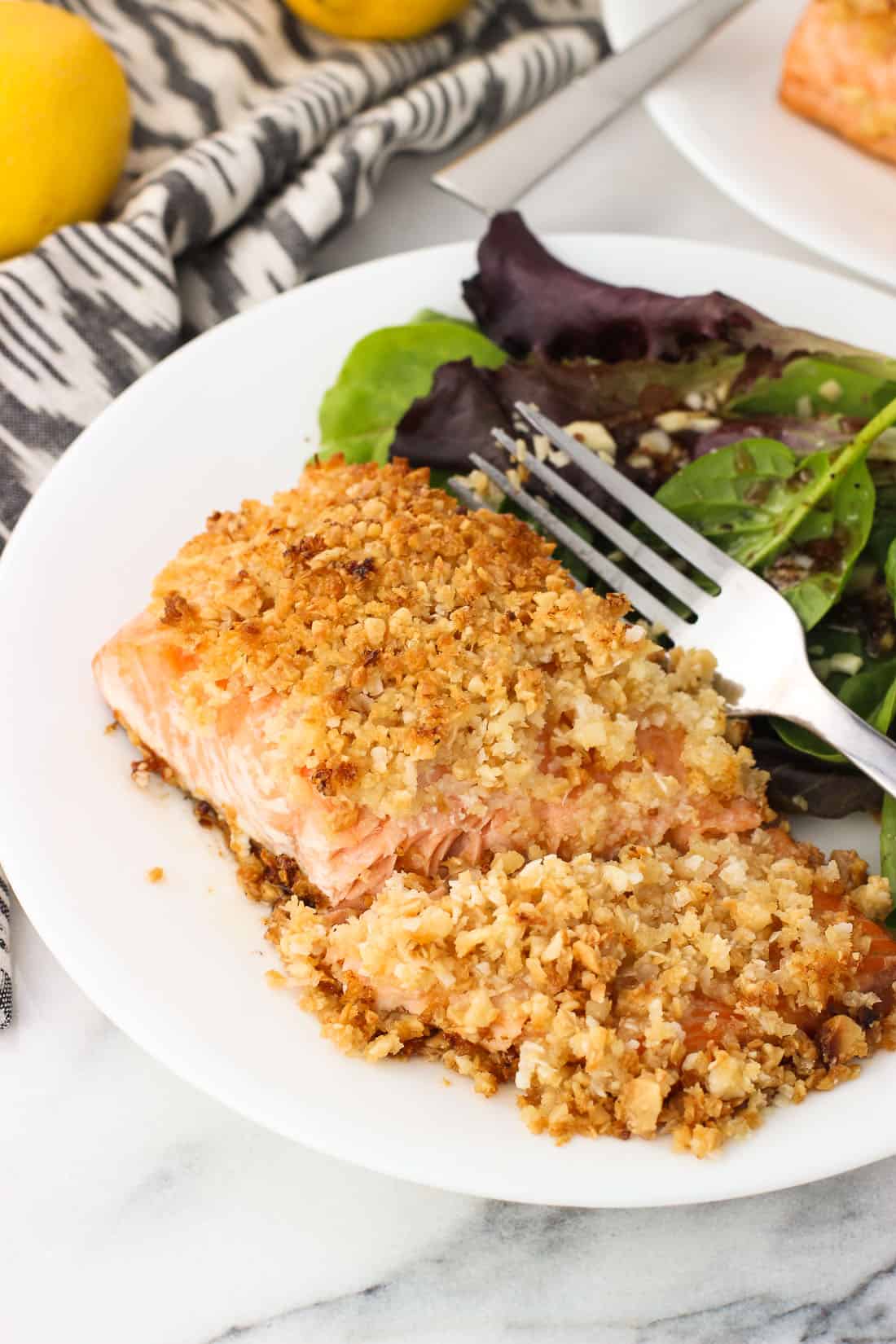 A cooked salmon fillet flaked on a plate