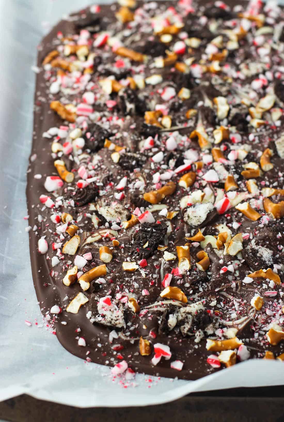 Hardened Oreo peppermint bark on a parchment-lined sheet pan.