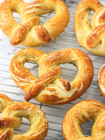 Pretzels cooling on a metal wire rack