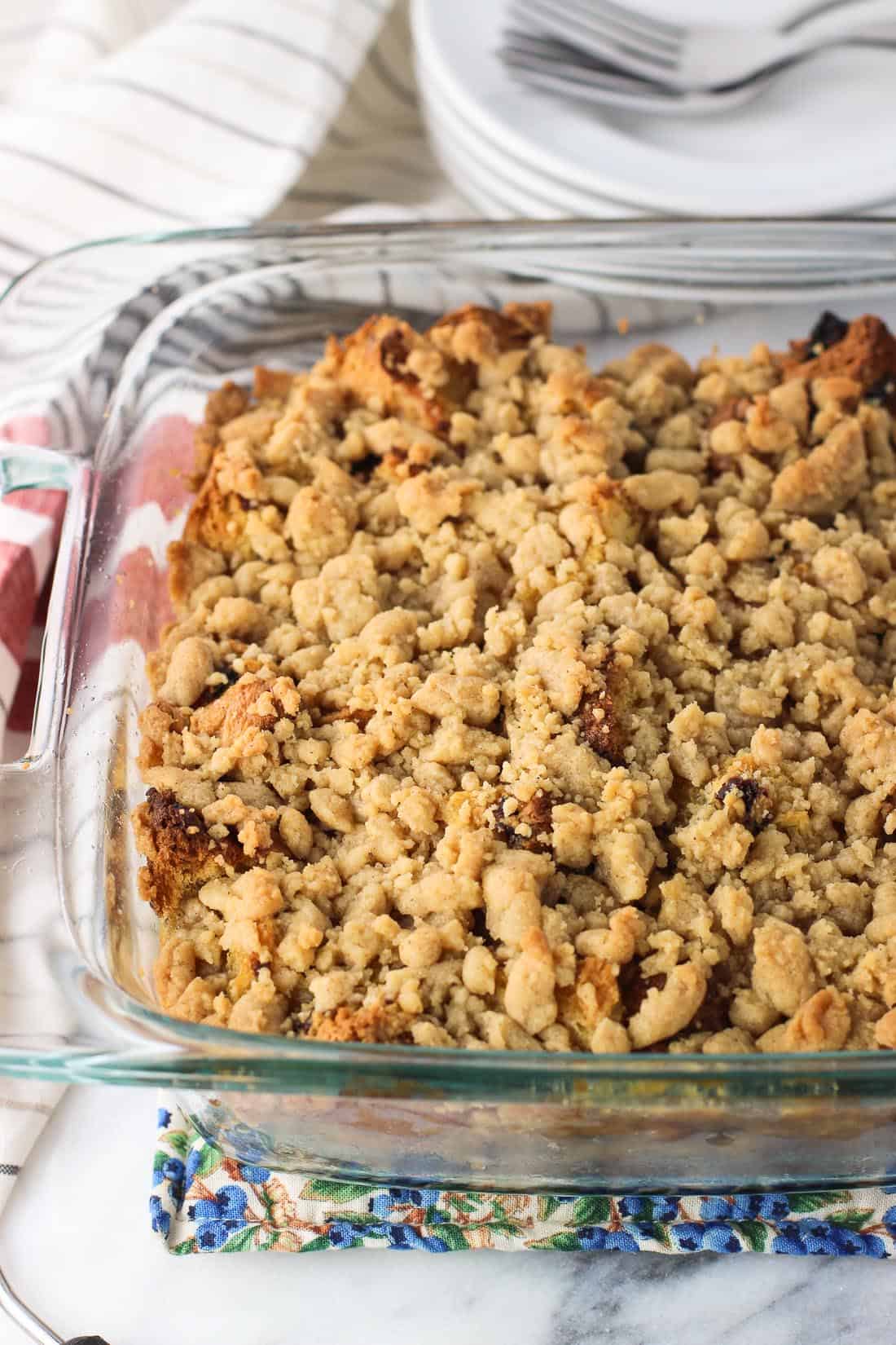 The french toast bake, covered in crumbs, in a glass baking dish right out of the oven