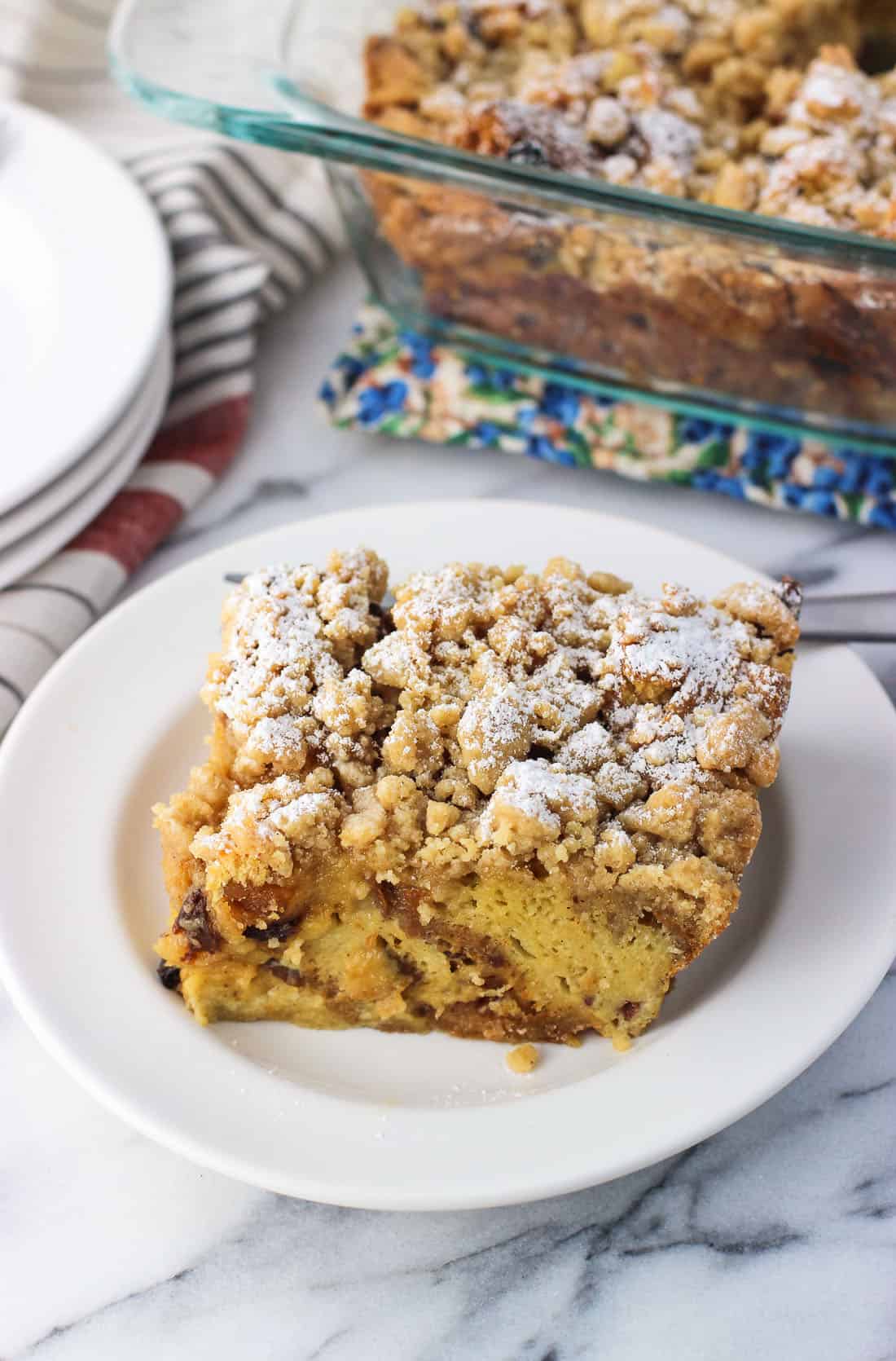 A square of crumb-topped panetonne french toast bake on a plate.