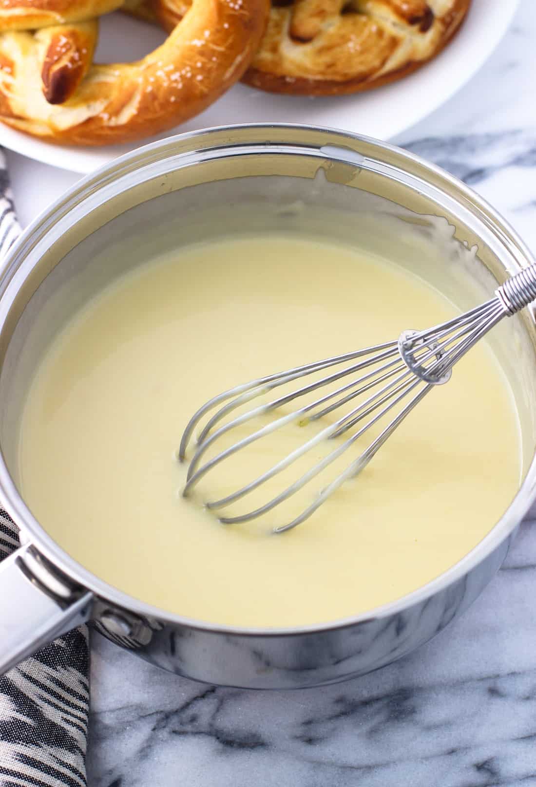 Creamy dip in a medium sauce pan with a whisk.