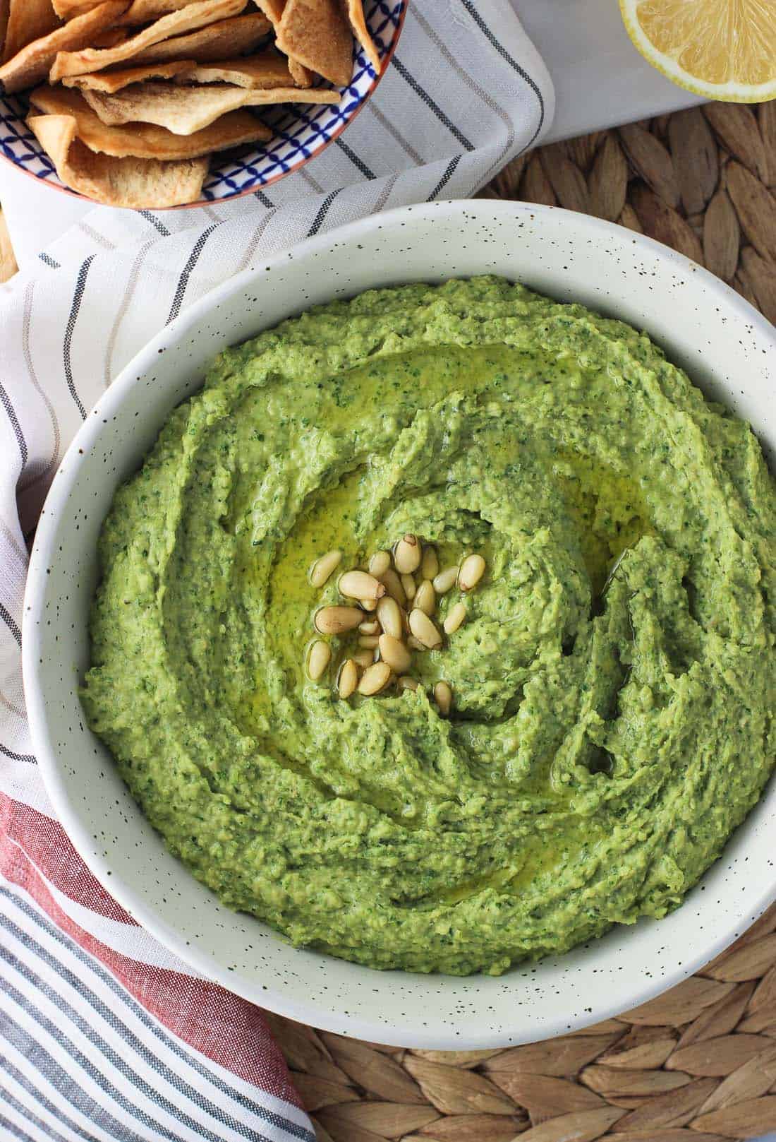 An overhead picture of hummus in a bowl next to pita chips