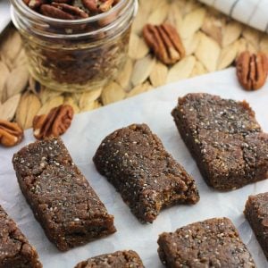 Sliced cinnamon pecan chia bars on a sheet of parchment paper.