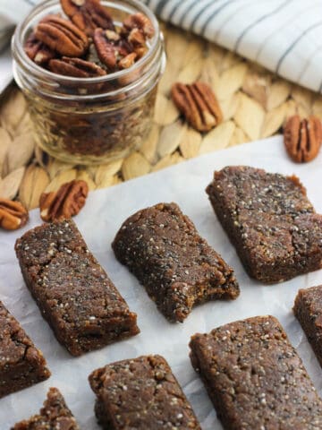 Sliced cinnamon pecan chia bars on a sheet of parchment paper.