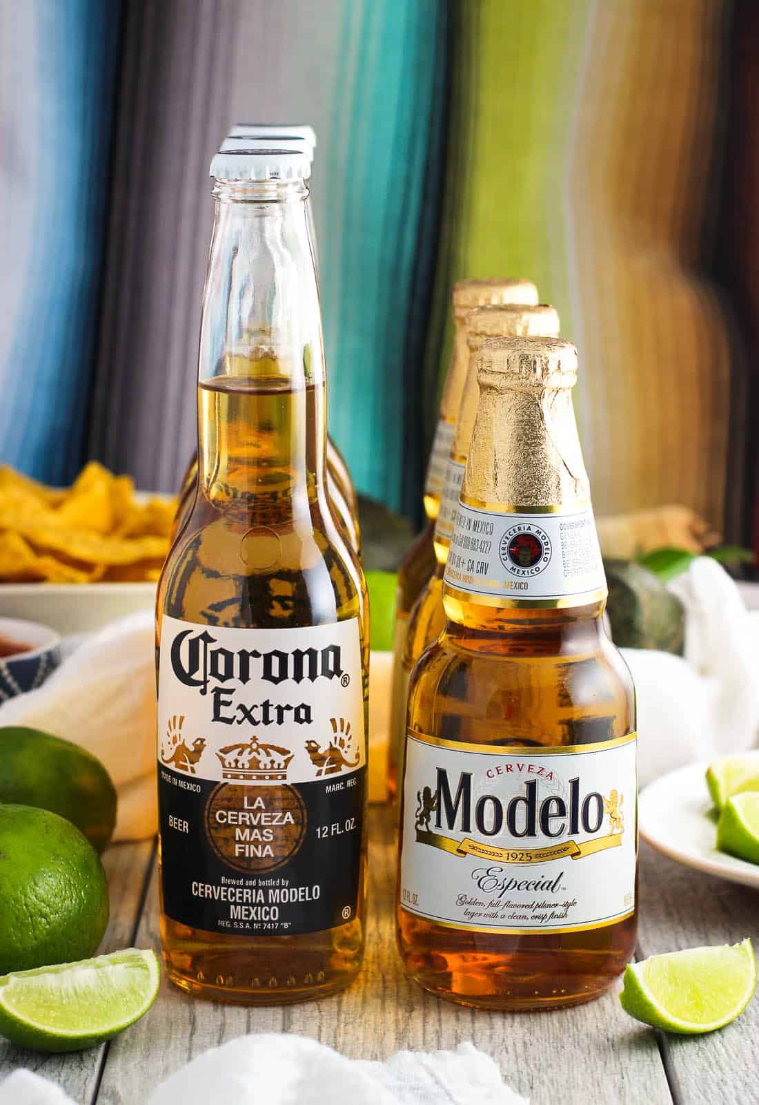 Bottles of Corona Extra and Modelo Especial on a table with a party spread.