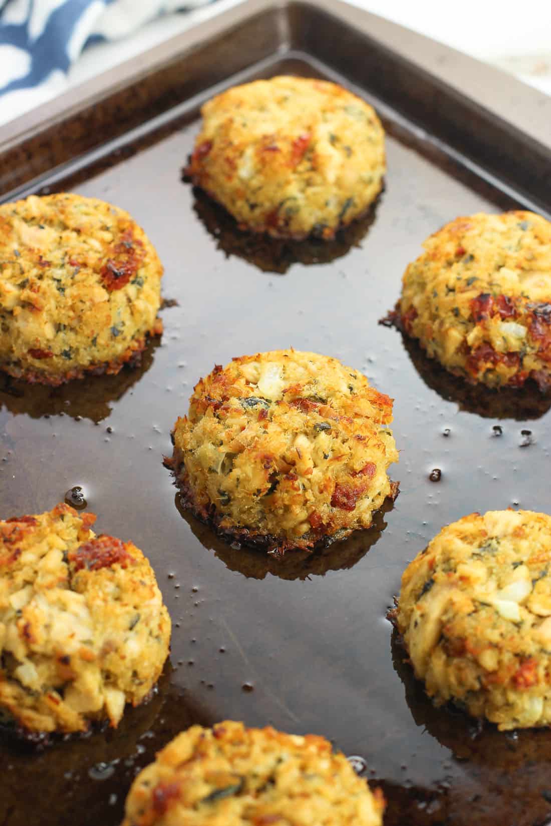 Baked and broiled tuna cakes still on the baking sheet just out of the oven