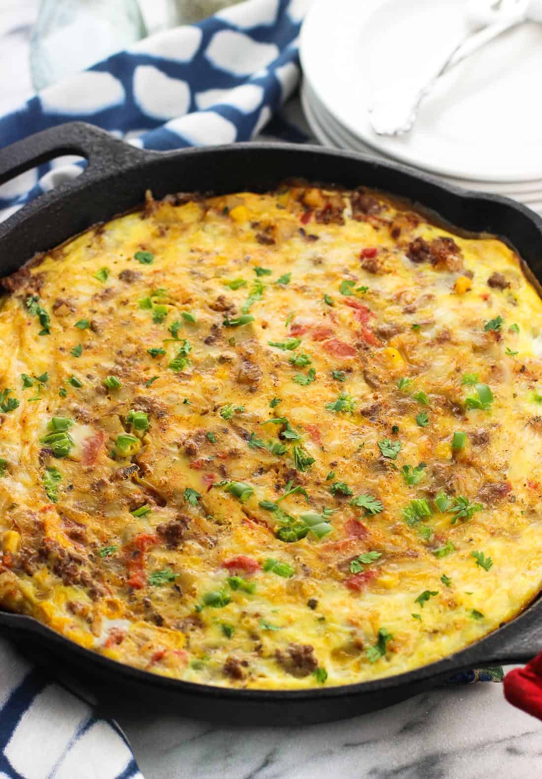 A baked southwestern frittata in a round cast iron pan.