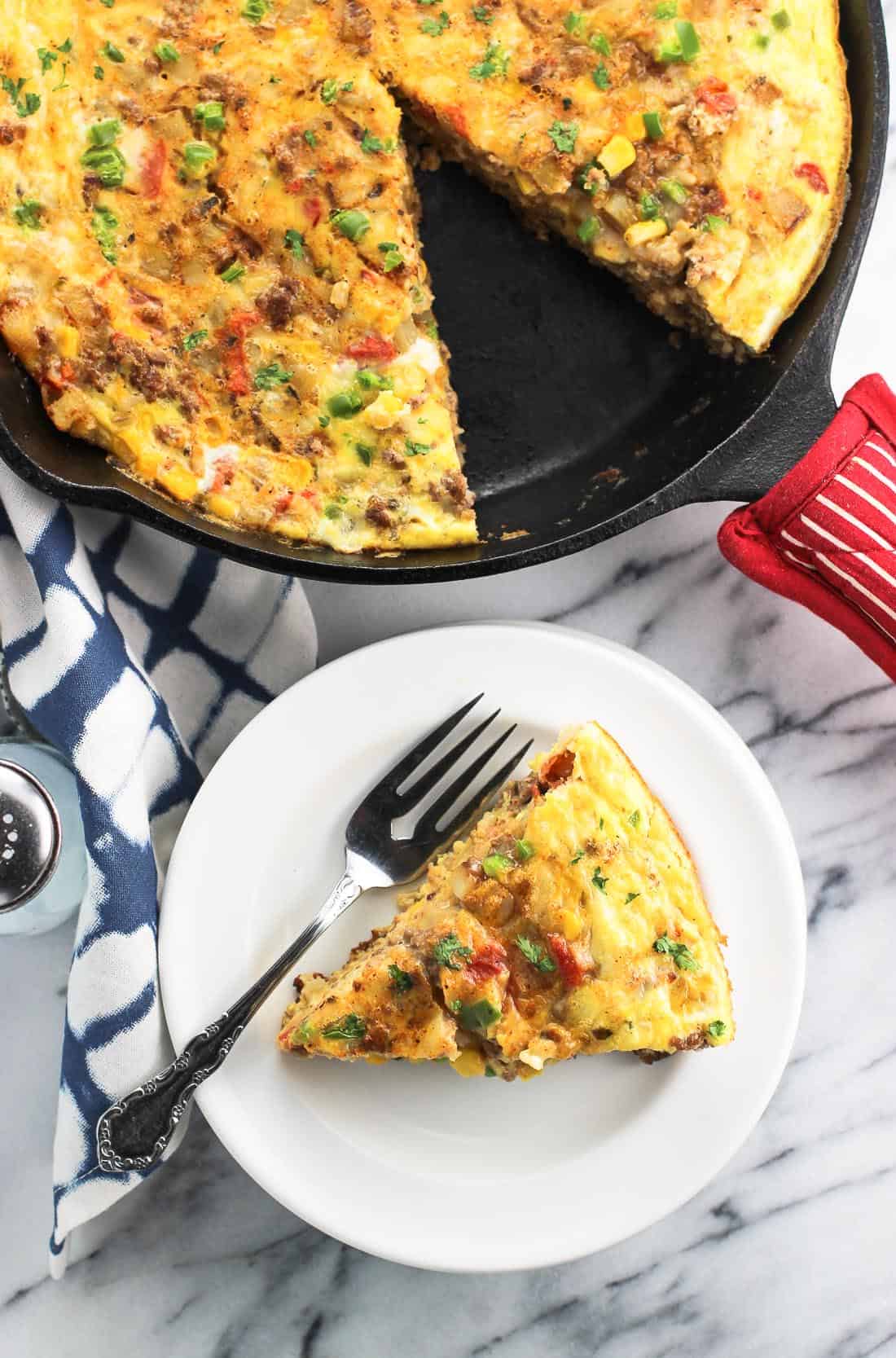 An overhead view of the frittata pan and a slice on a plate.