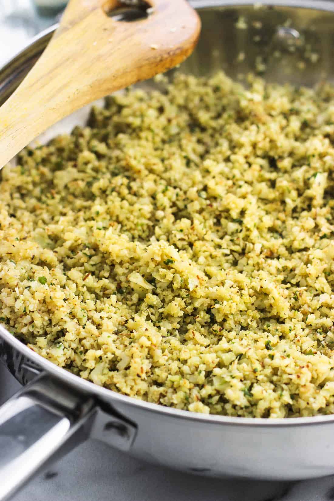 A skillet filled with pesto cauliflower rice. 