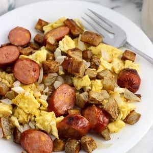 A serving of the sausage and egg scramble on a plate with a fork.