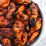 A large serving bowl of grilled wings.