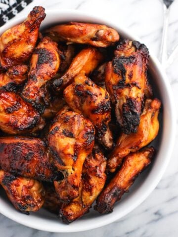 A large serving bowl of grilled wings.