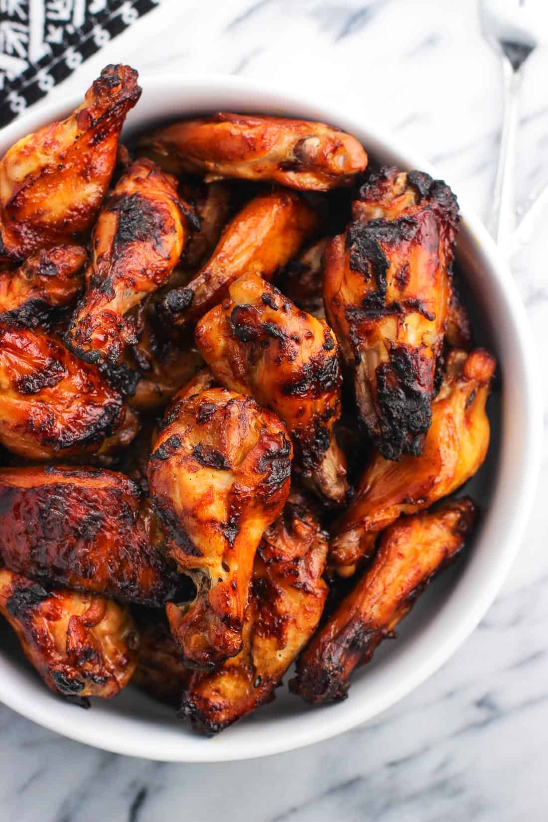 A large serving bowl of grilled wings.
