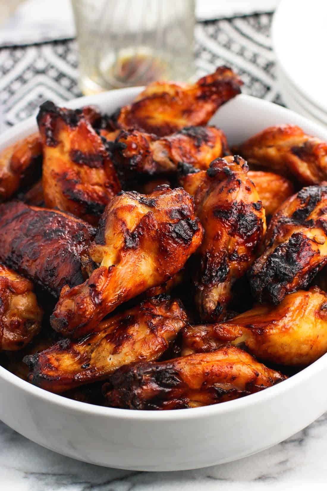 Grilled wing segments in a big bowl.