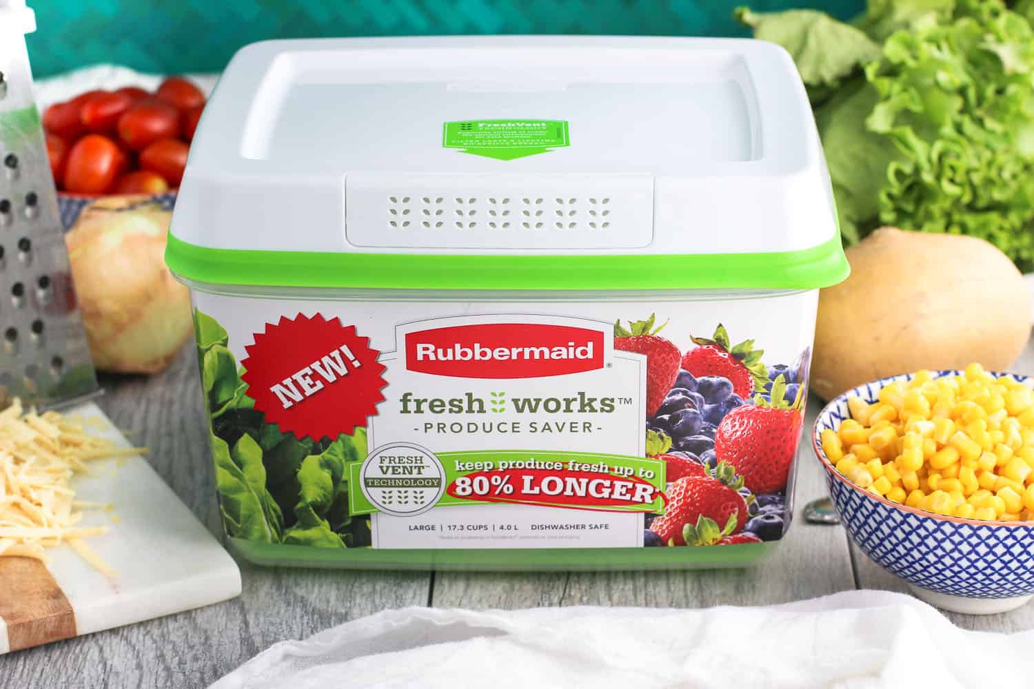 A new Rubbermaid fresh works produce saver surrounded by salad ingredients.