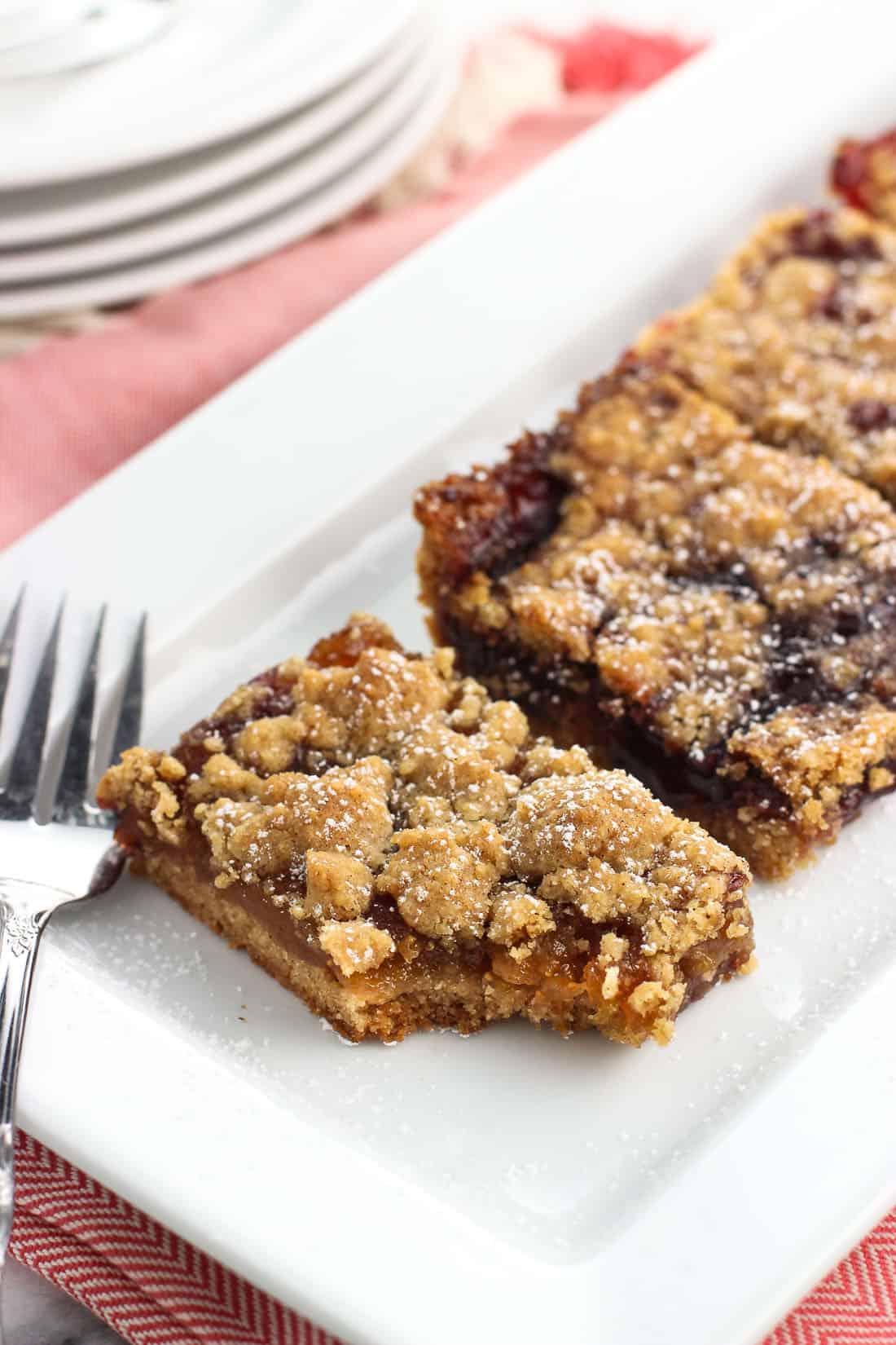 Jam bars on a rectangular serving tray with a bite taken out of the front one