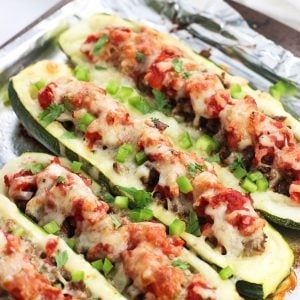 Taco zucchini boats on a foil-lined sheet pan after baking.