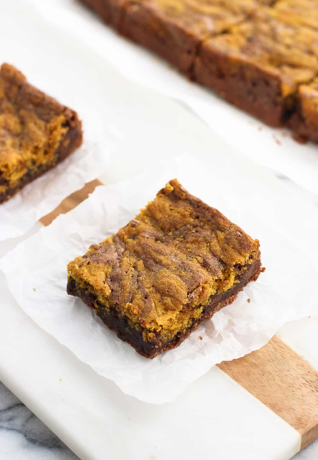 A brownie on a square of crinkled parchment paper