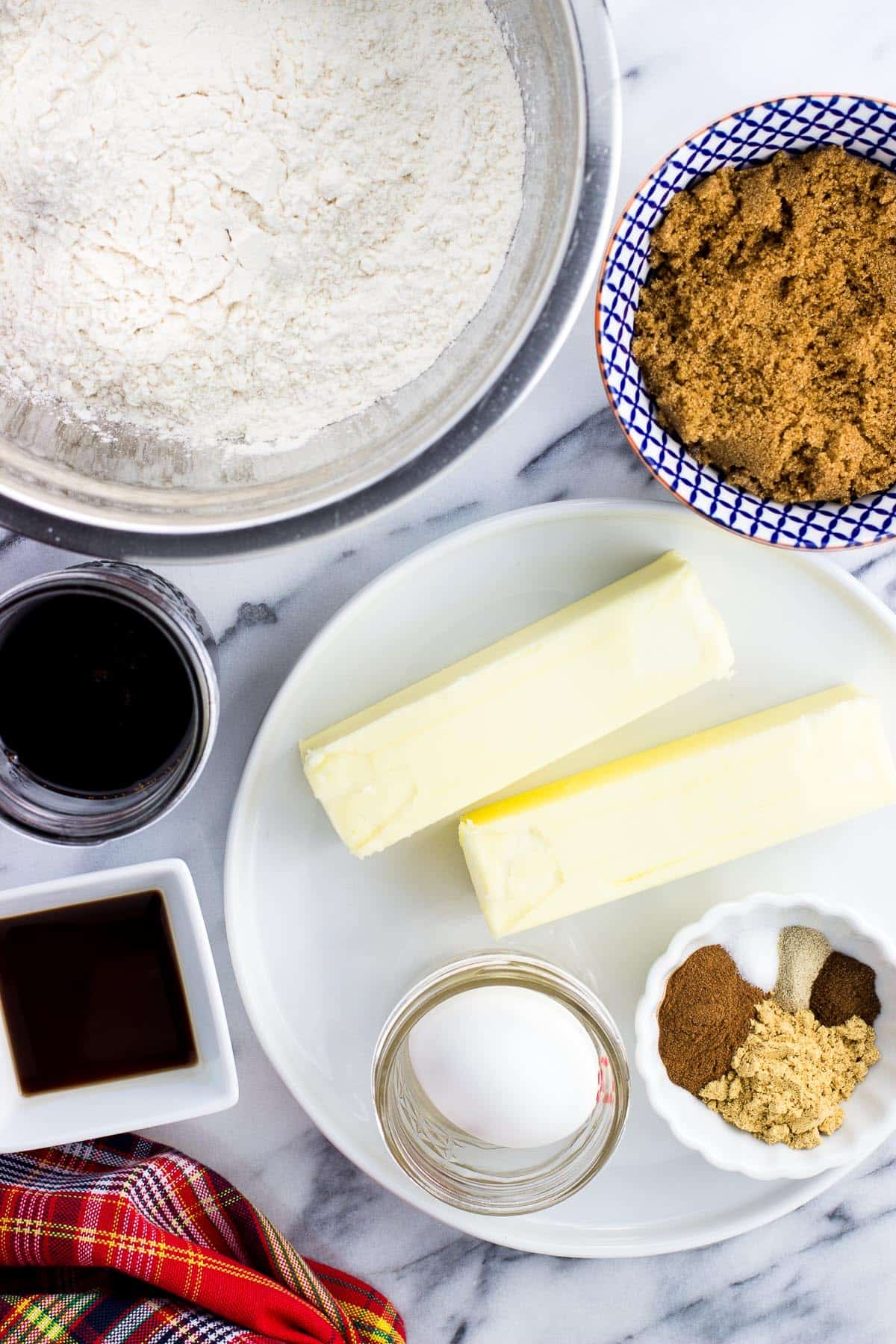 An overhead picture of all of the recipe ingredients in separate containers and bowls on a marble board.