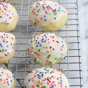 Iced anise cookies lined up on a wire rack.