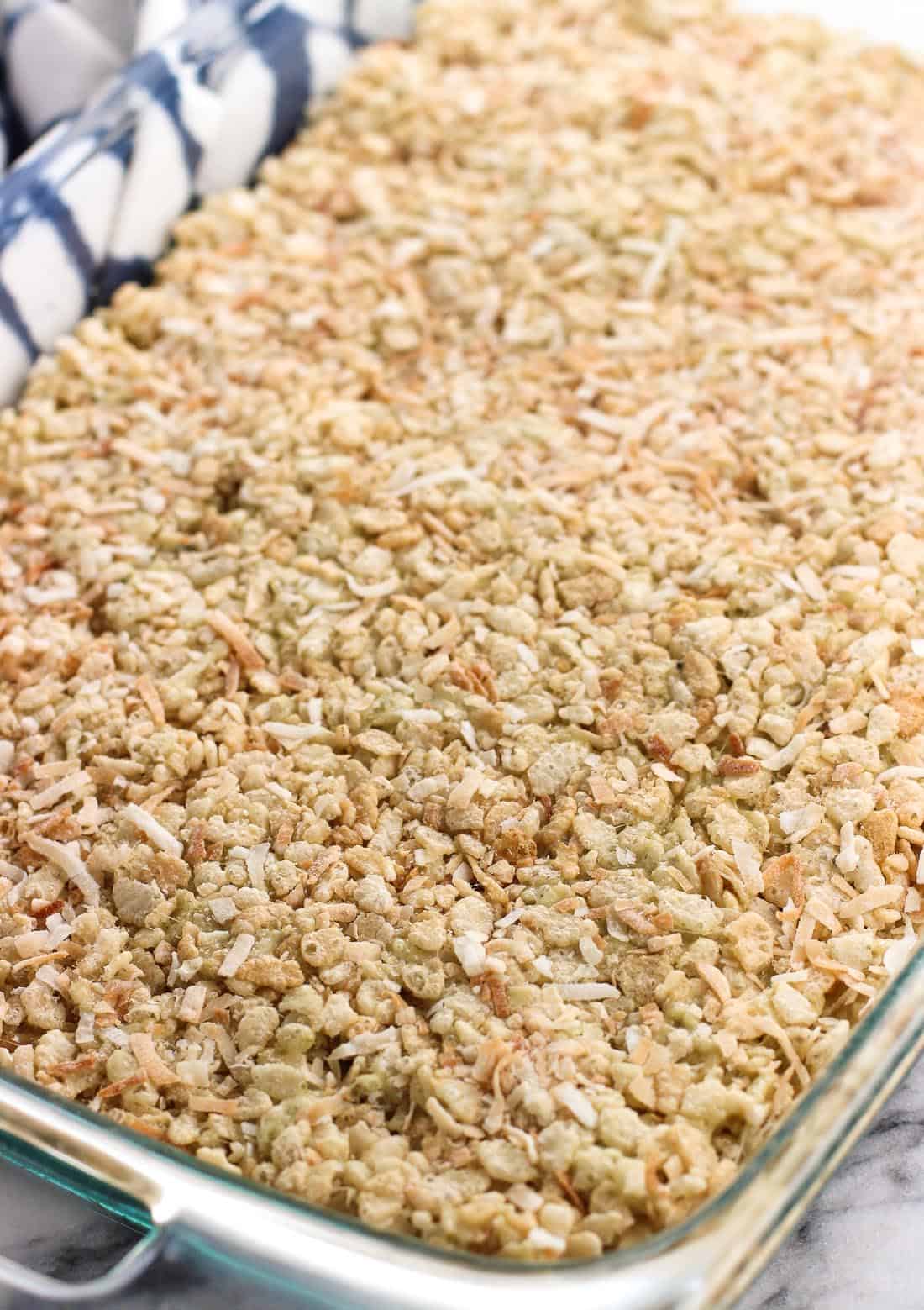 The rice crispy mixture pressed evenly into a rectangular glass dish.