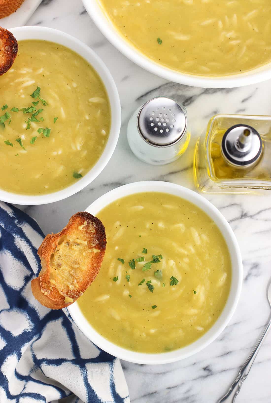 Bowls of potato leek soup with garlic crostini.