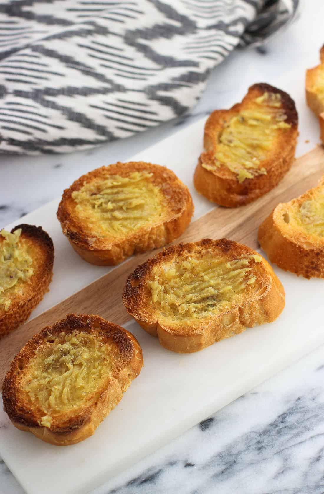 Roasted garlic spread onto toasted crostini.