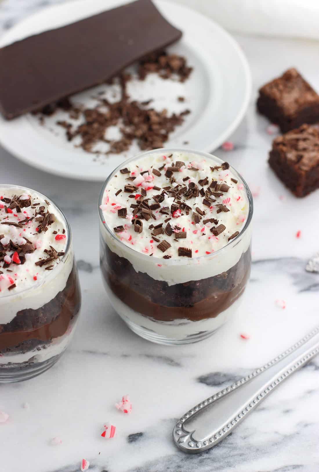 Two small glasses filled with the layered trifle mixture.