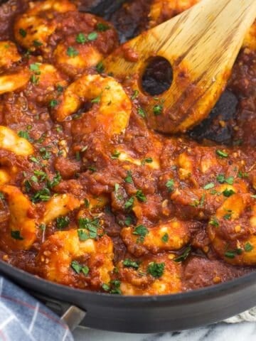 Cooked shrimp in a skillet in spicy tomato sauce
