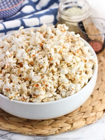 A serving bowl filled with seasoned popcorn.