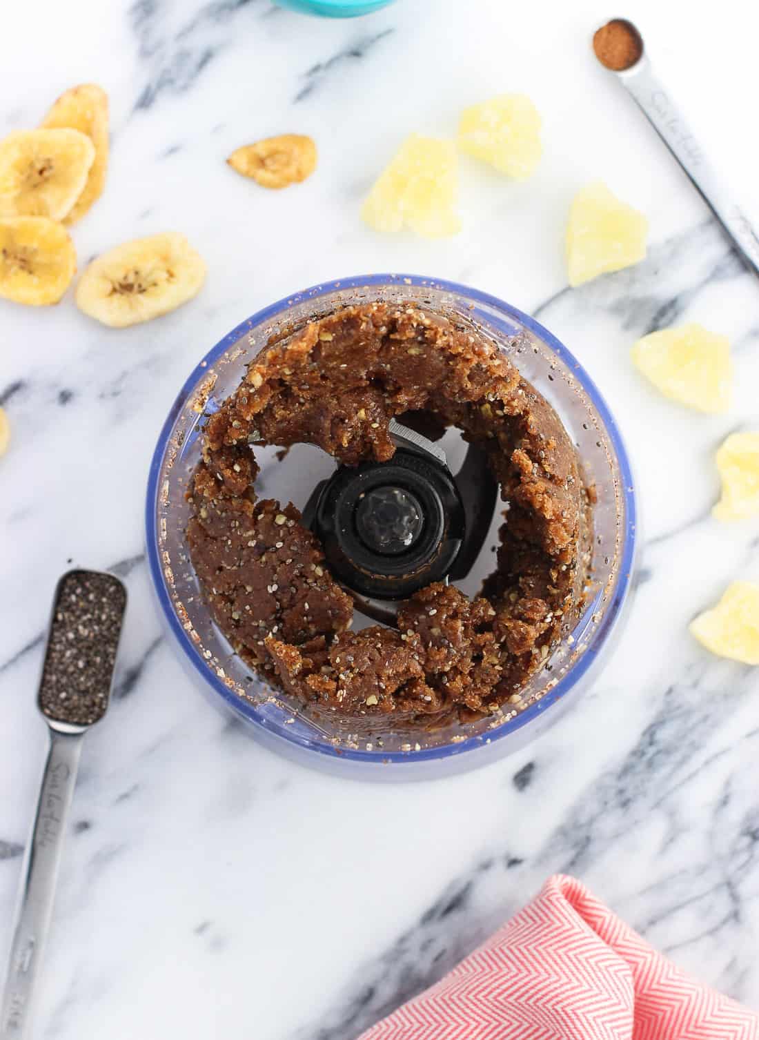 Cohesive chia bar mixture in the food processor after blending.